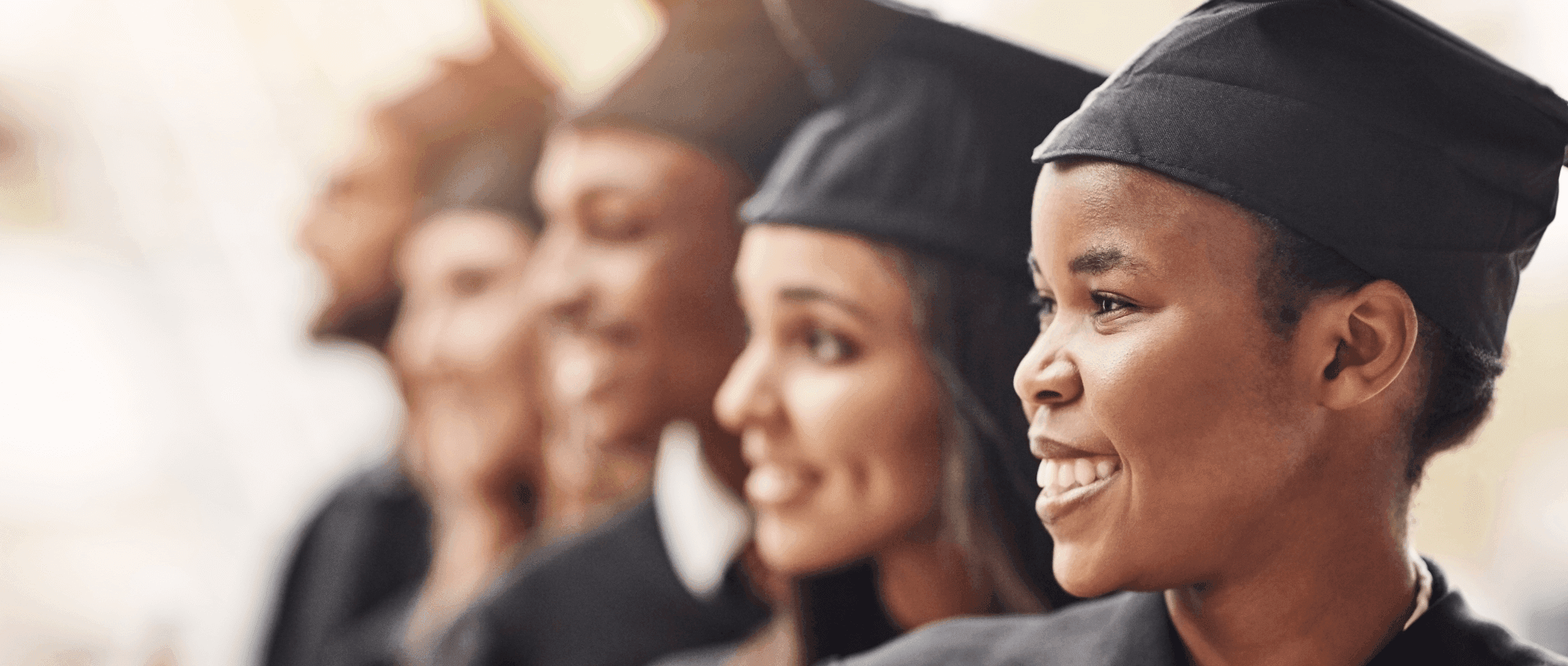 smiling graduates in a row