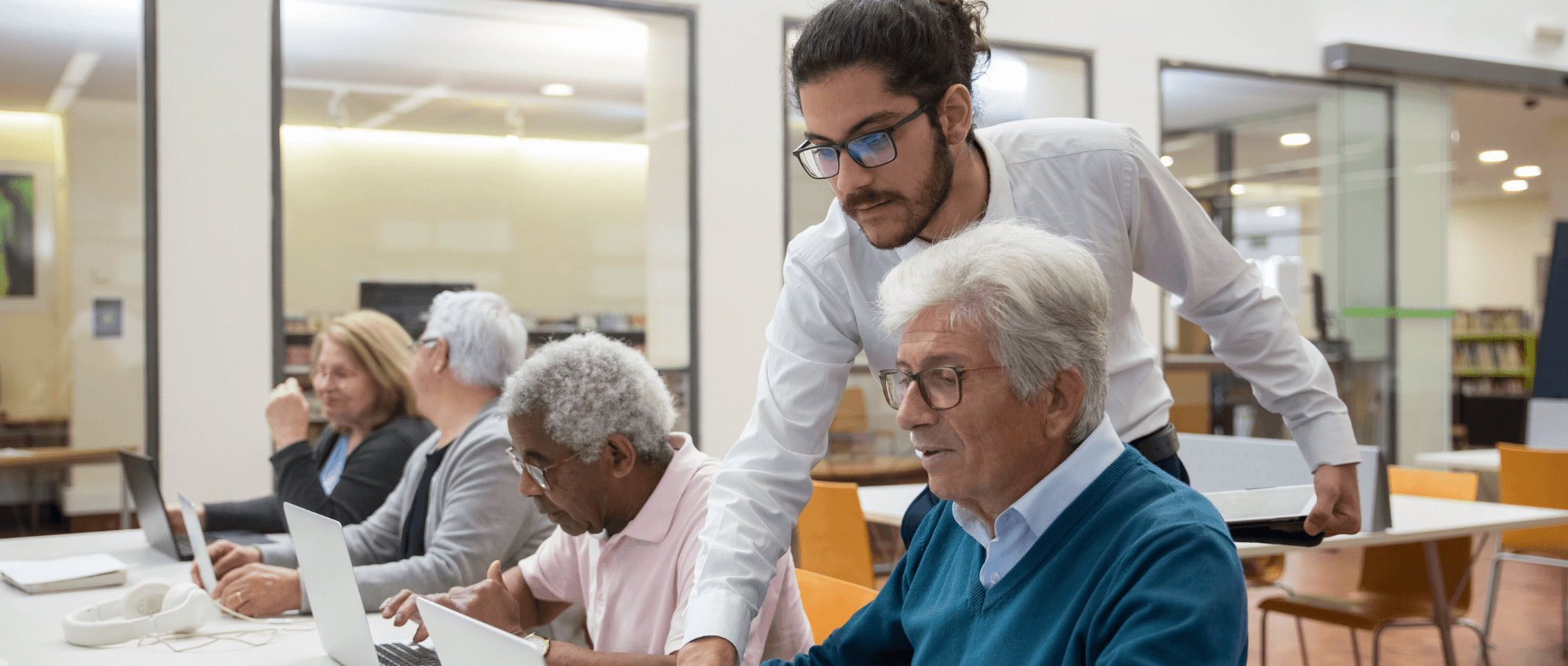 man helping senior with computer