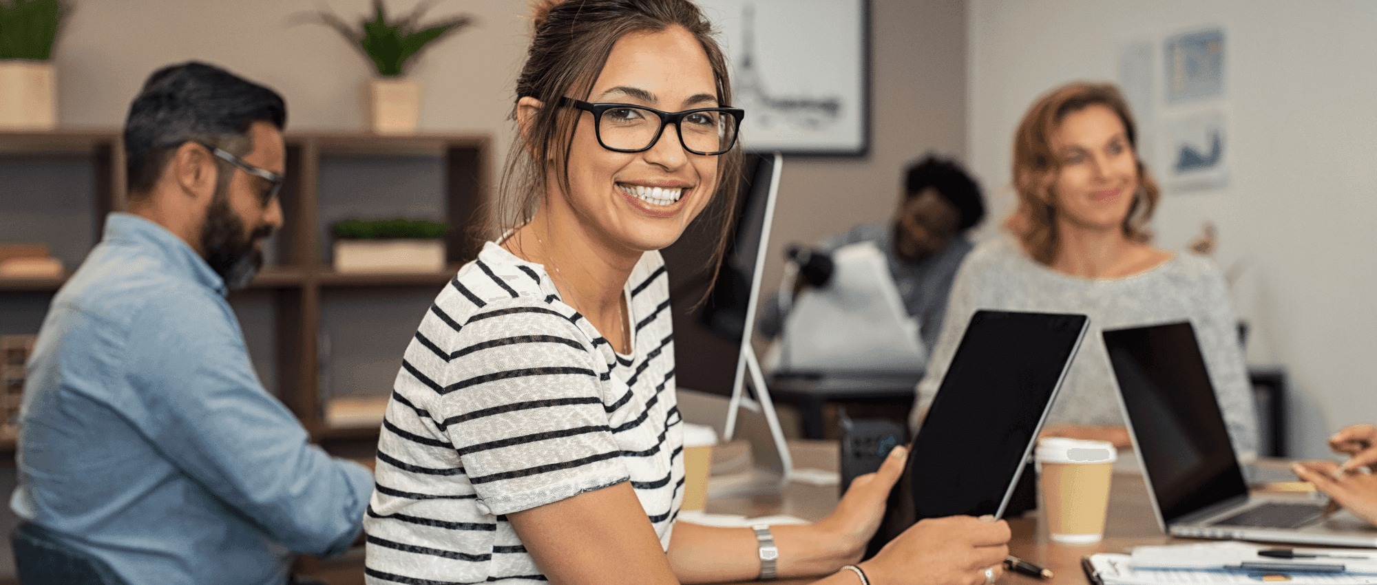 smiling woman holding tablet
