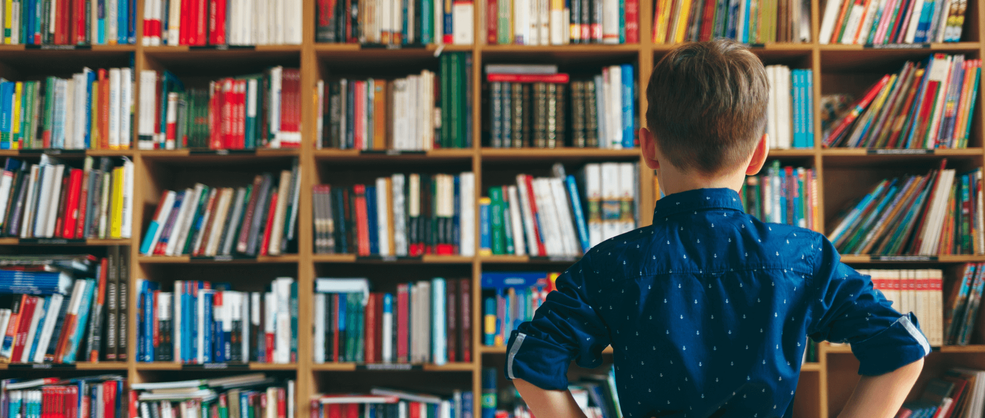 child looking at books in a library