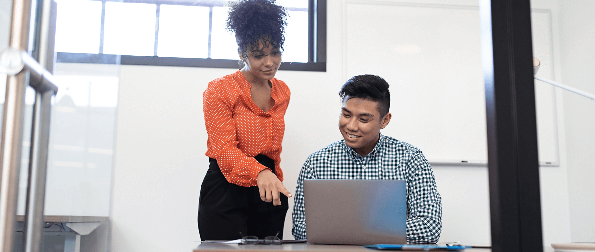 young woman teaching young man