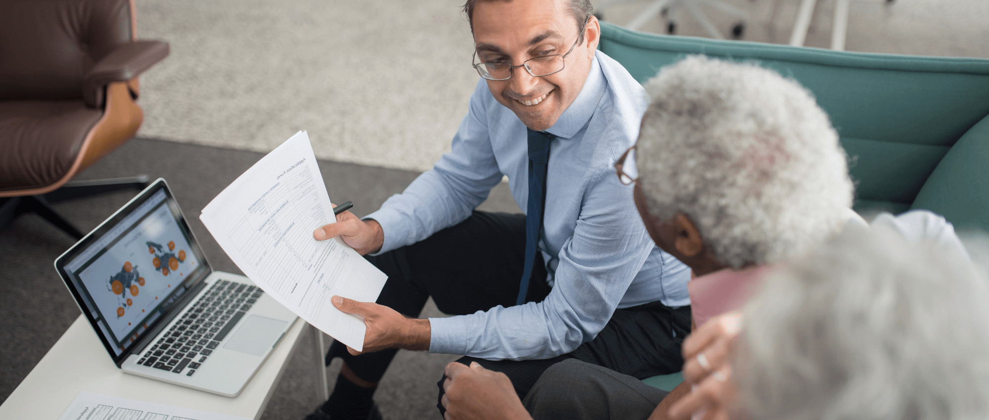 man showing forms to older couple