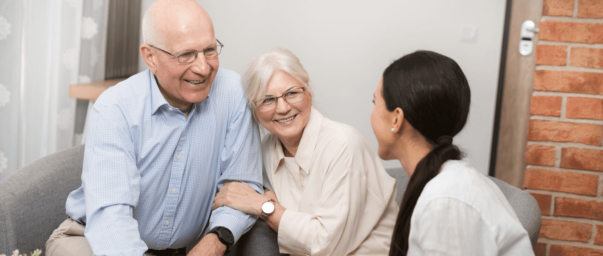 elderly couple speaking with woman