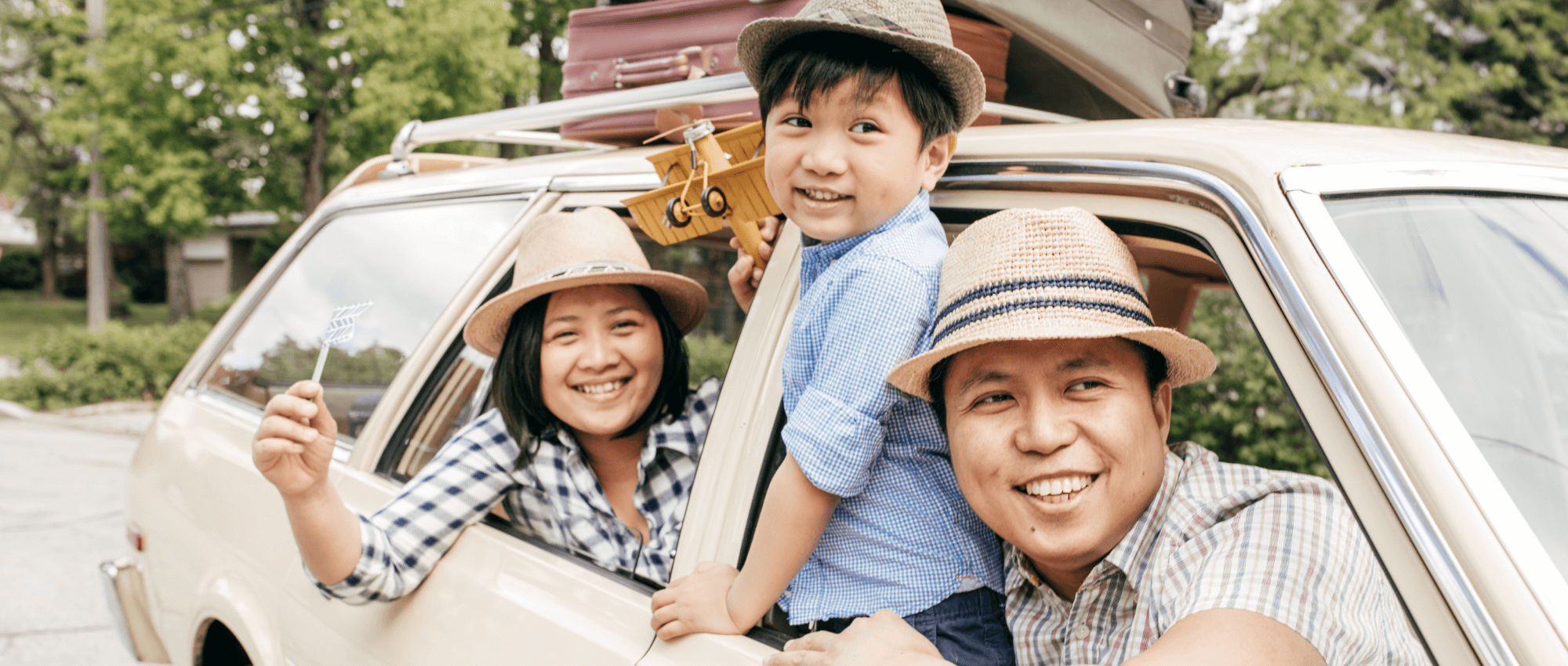 smiling asian family in car