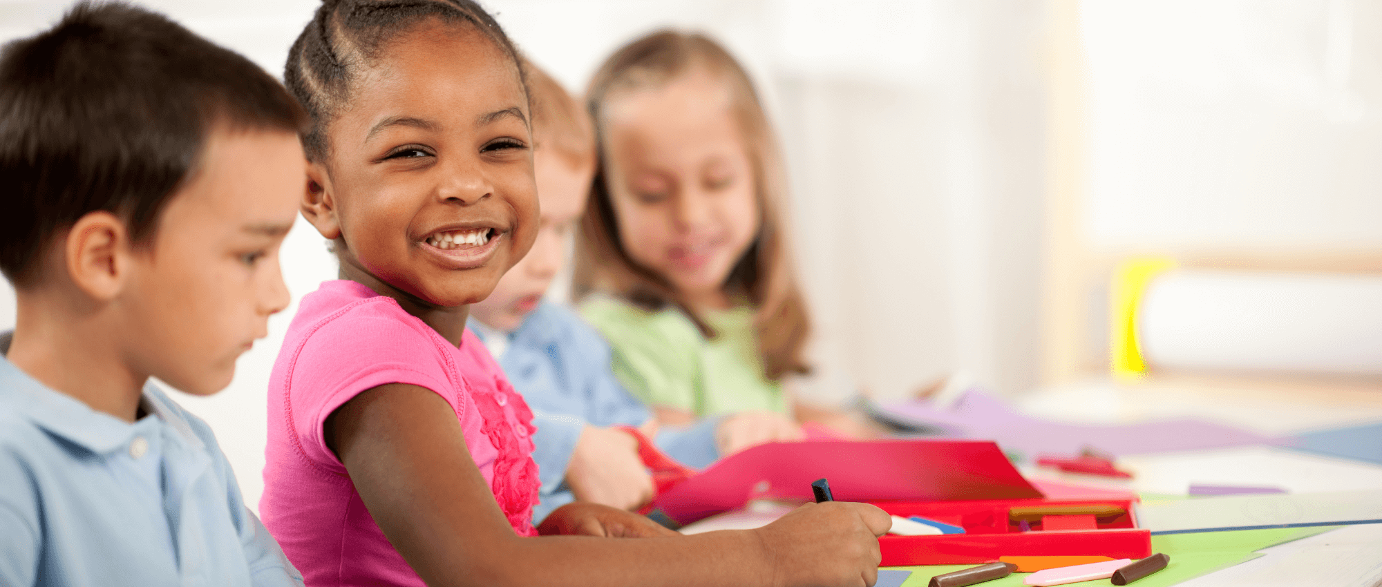 children drawing on construction paper