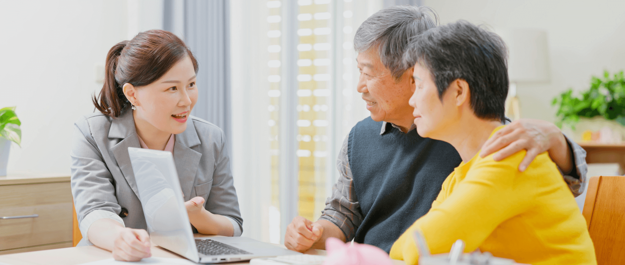 older asian couple talking to young woman