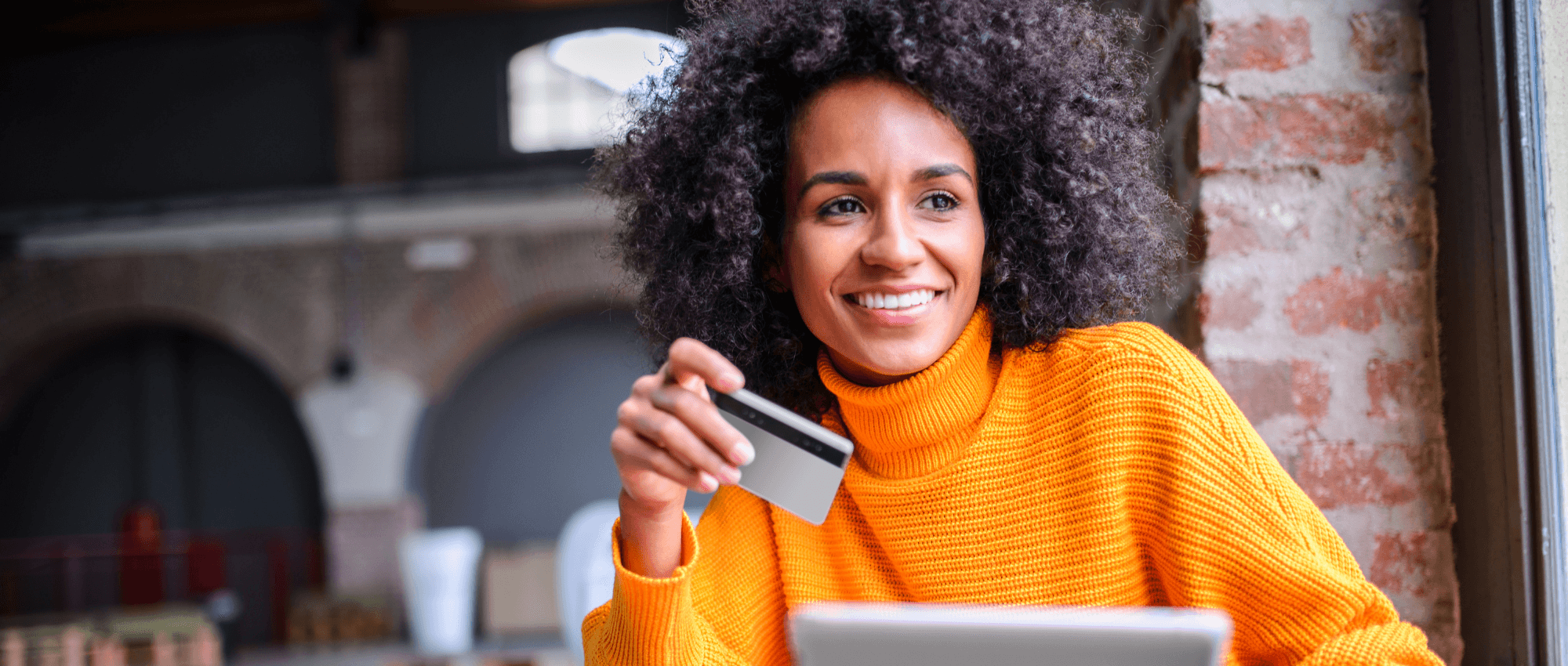 A lady holding a credit card