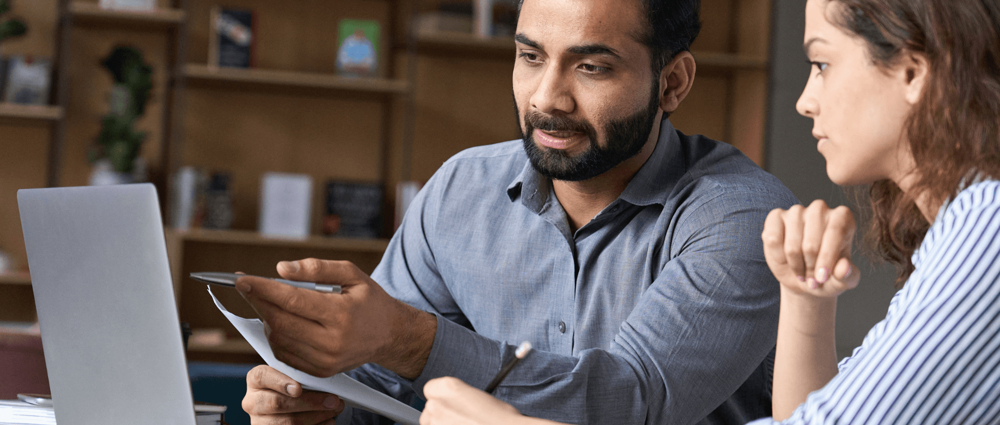 Someone explaining something on the laptop