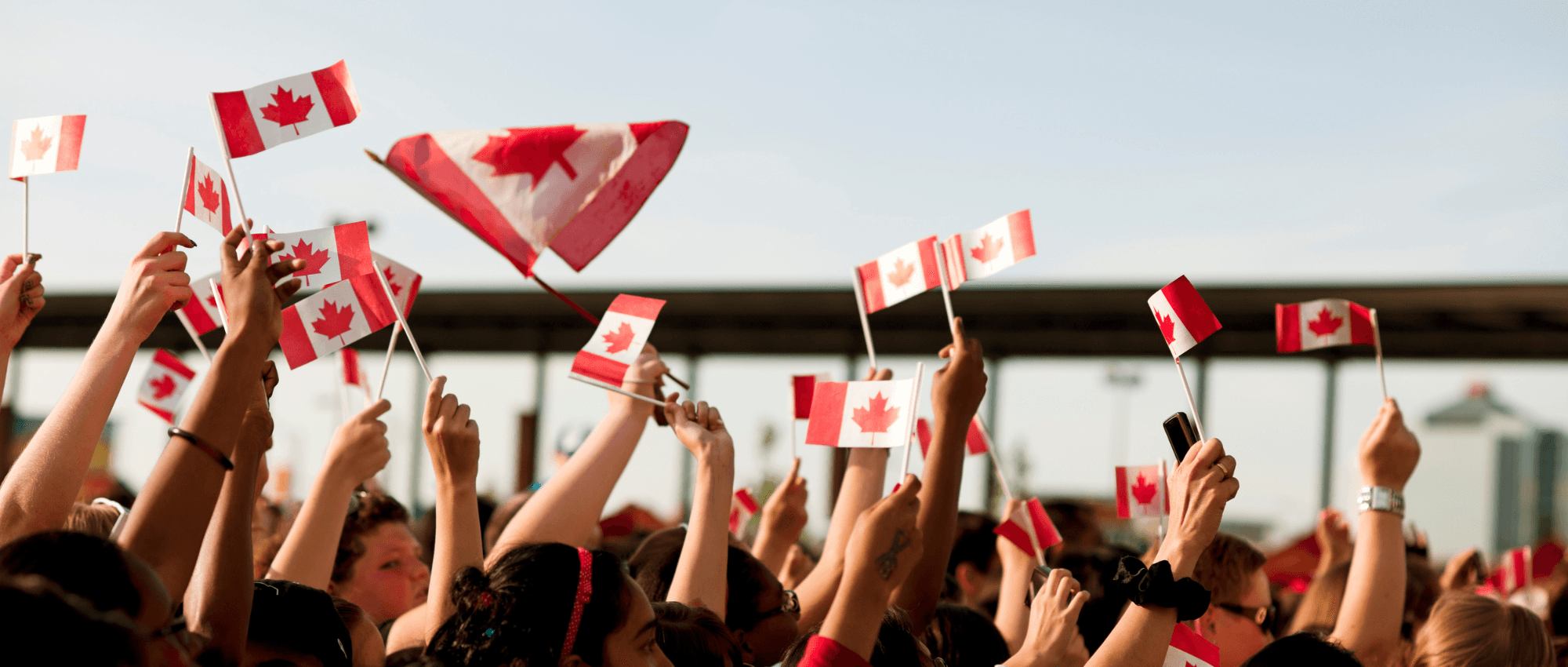 People waving the Canadian flag