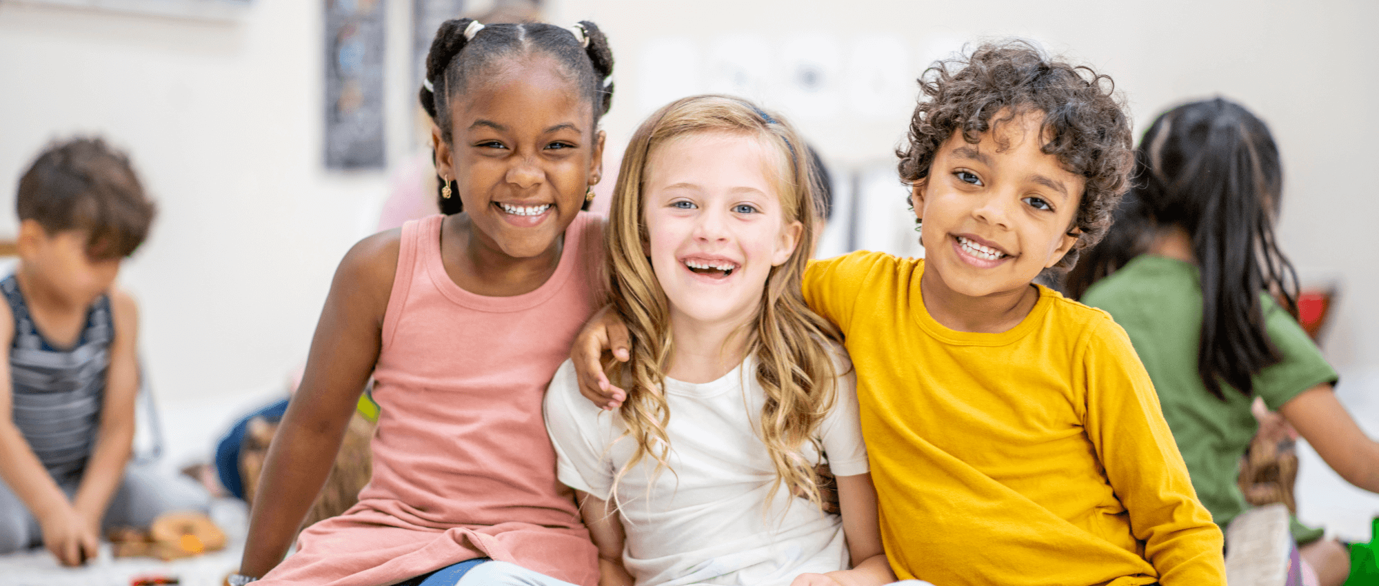 Children smiling in a classroom