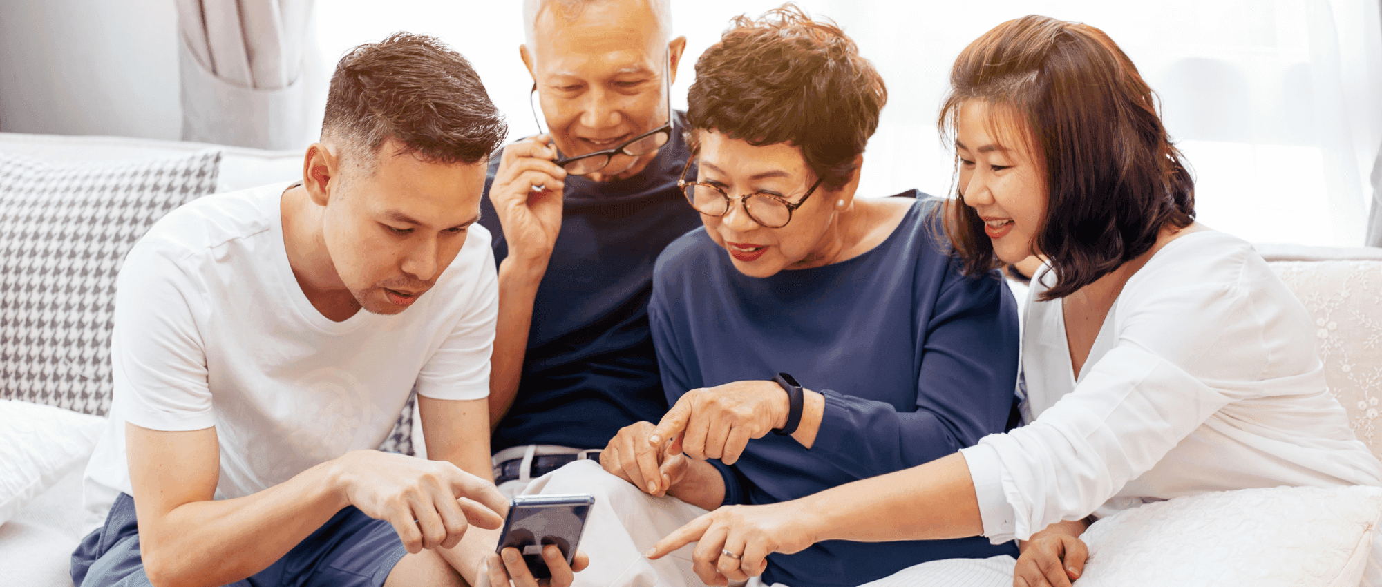 A group of Asians pointing on a mobile