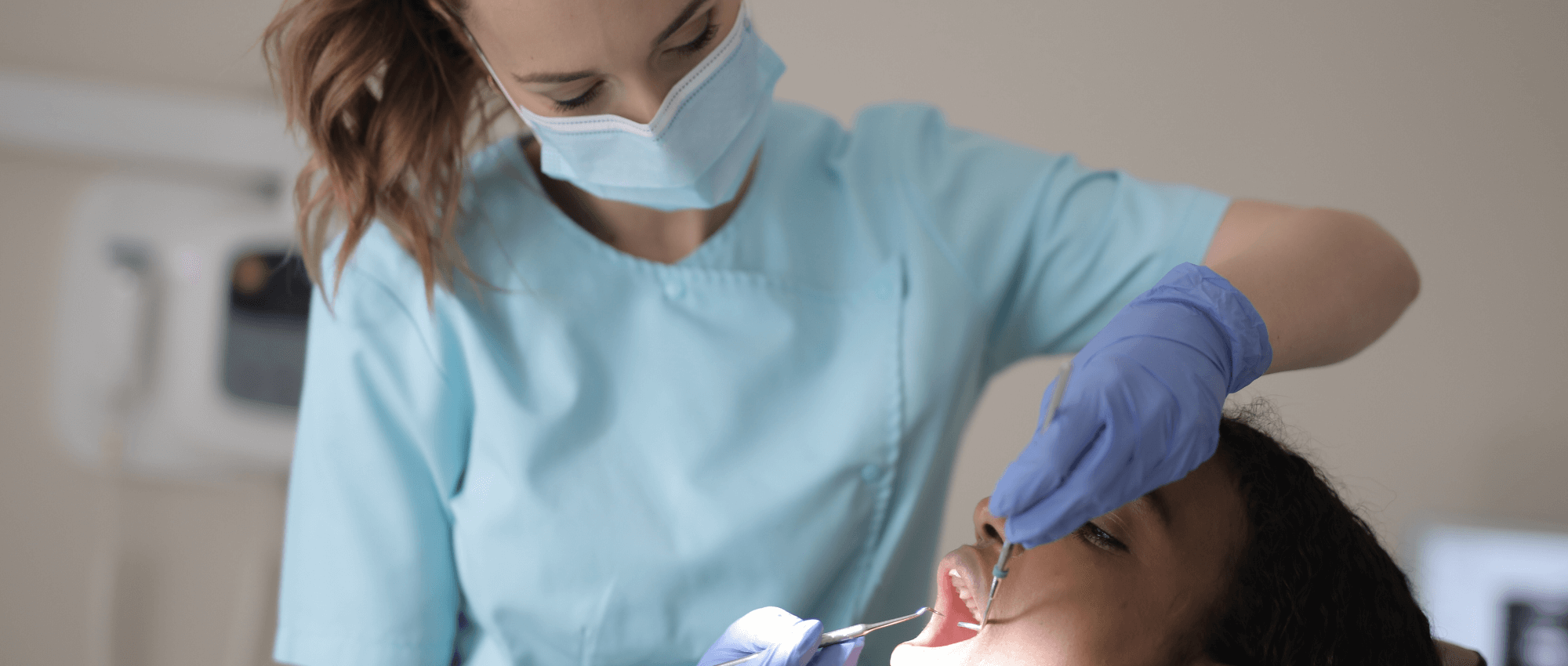 Dentist looking inside a patient's mouth