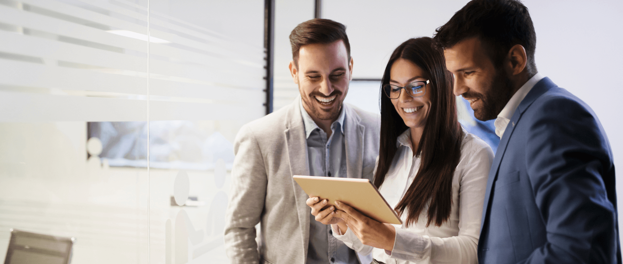 Staff looking at an i-pad and smiling
