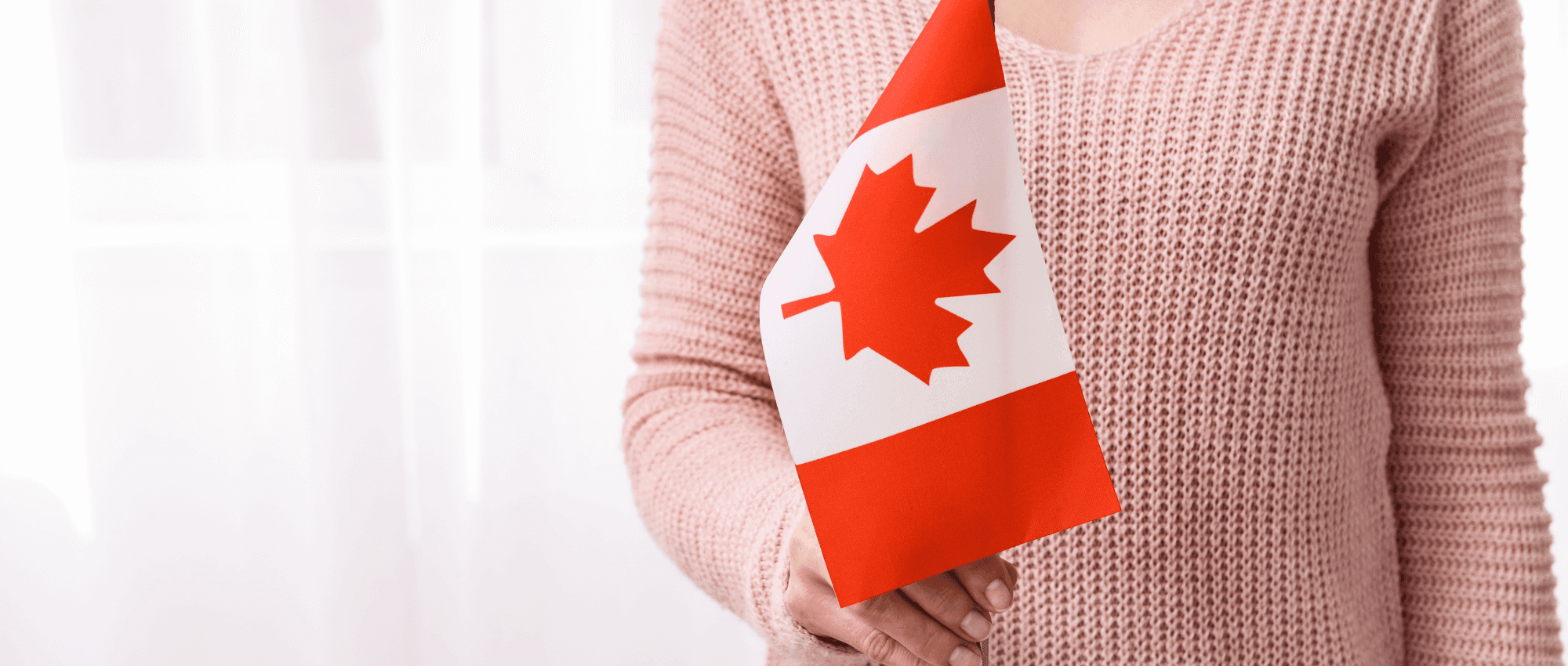 A person holding the Canadian flag