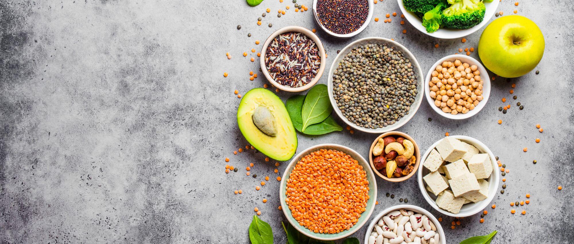 Nutritional beans, an apple and avocado on a silver table