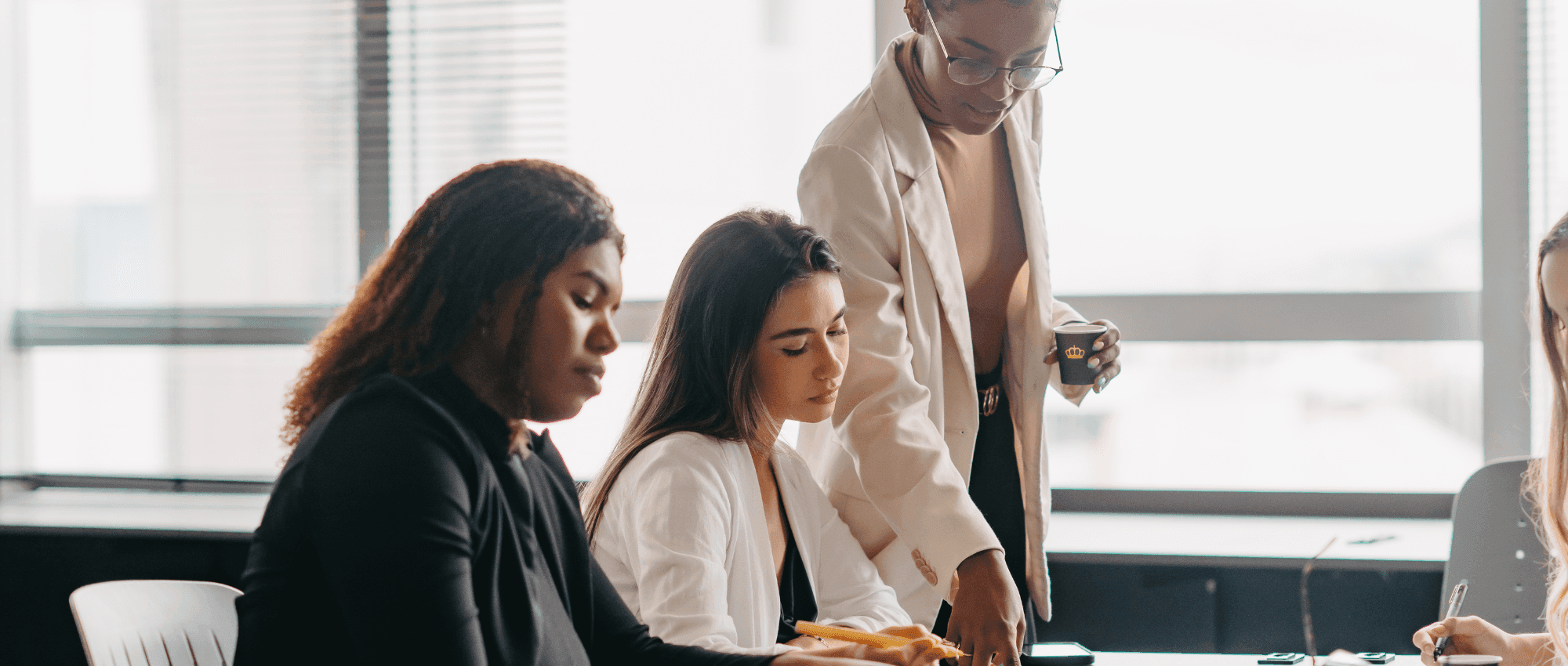 A manager explaining something to her staff in a meeting