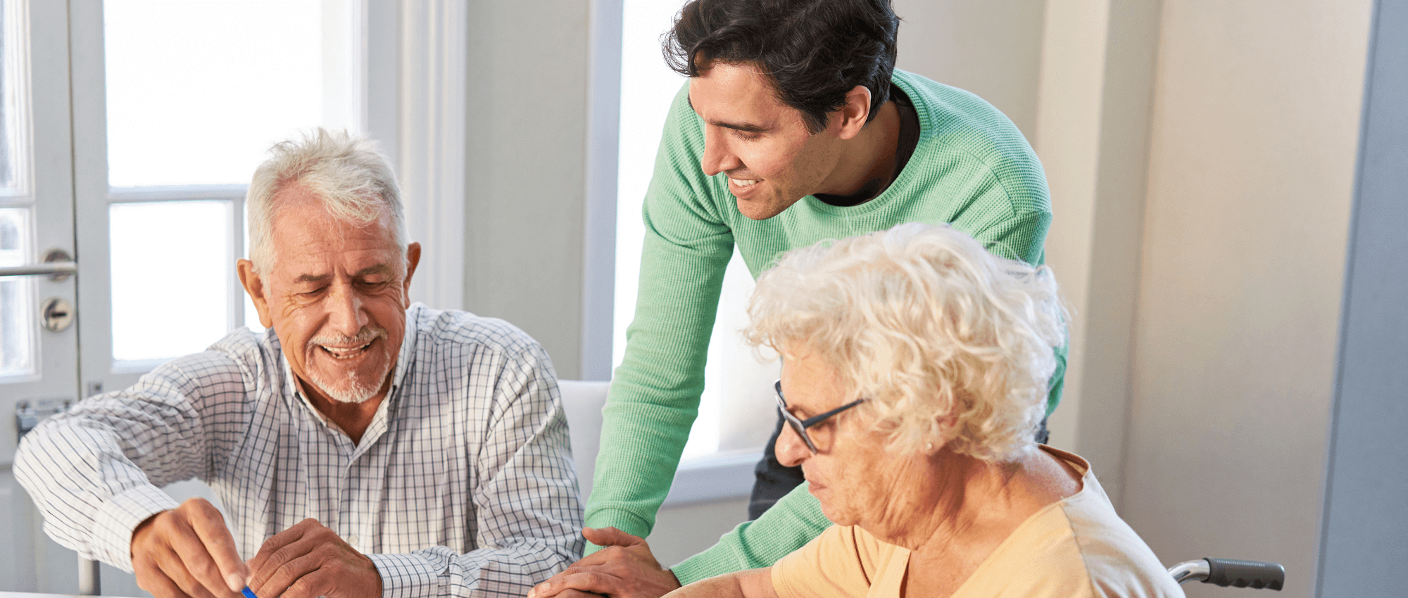 An young adult helping two seniors