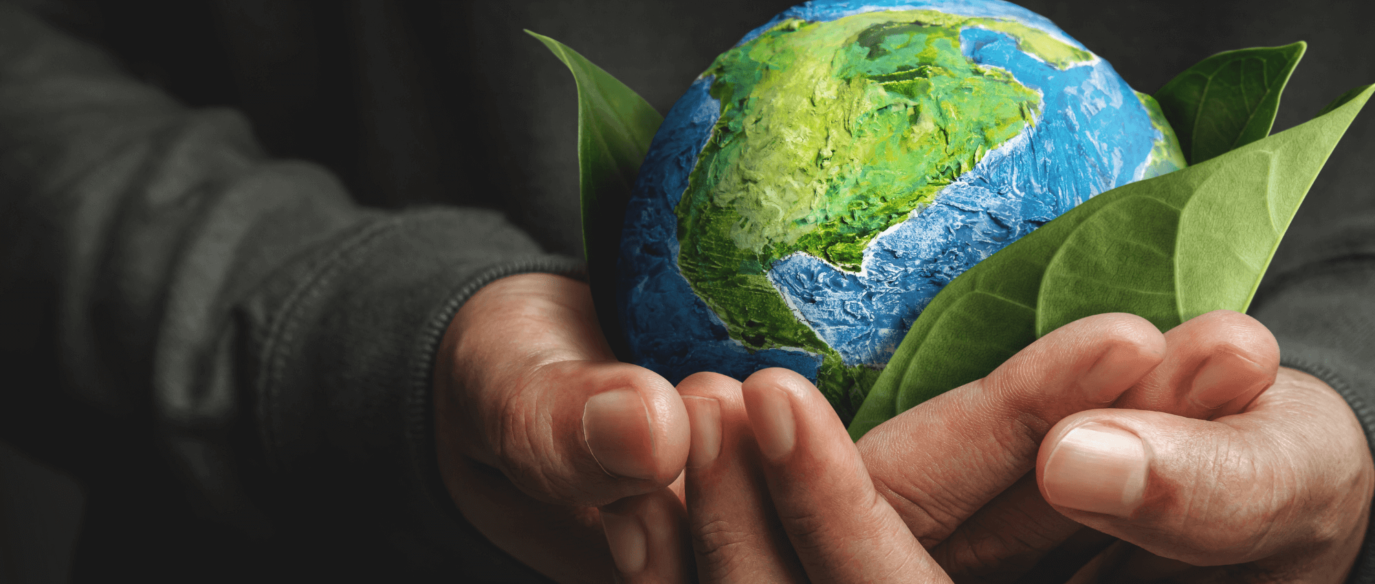 person holding an earth replica