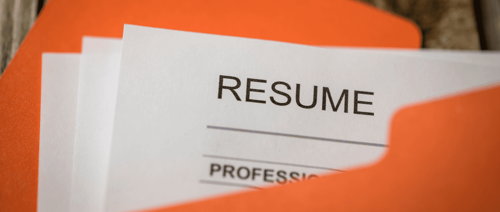 A resume in an orange folder