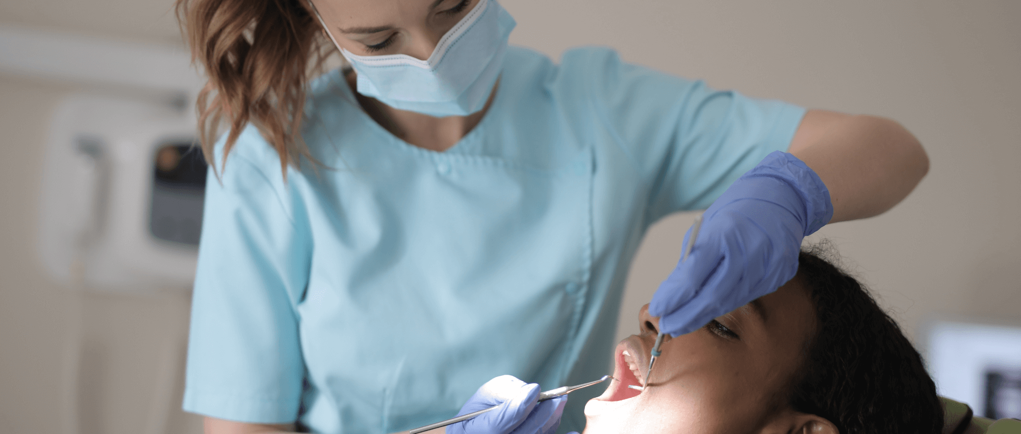 Dentist cleaning a person's teeth