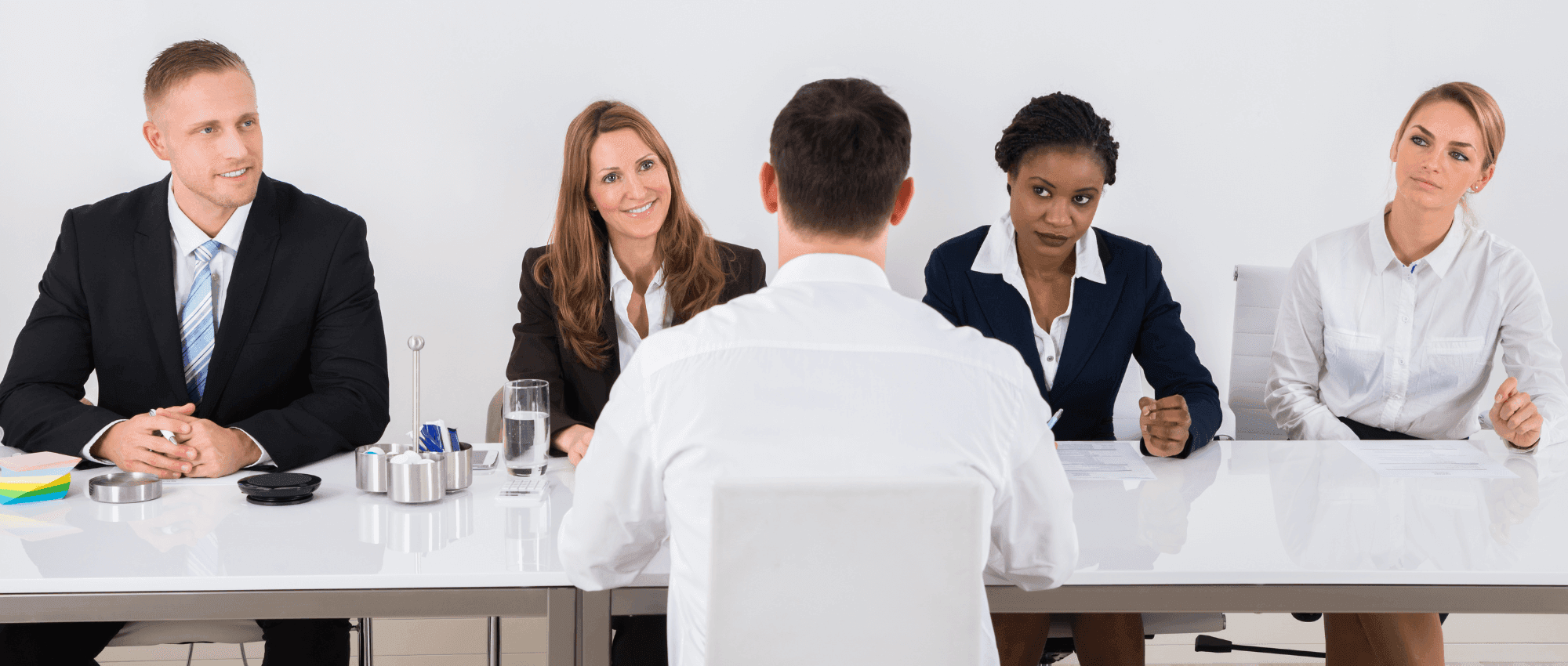 A person being interviewed by a group of professionals