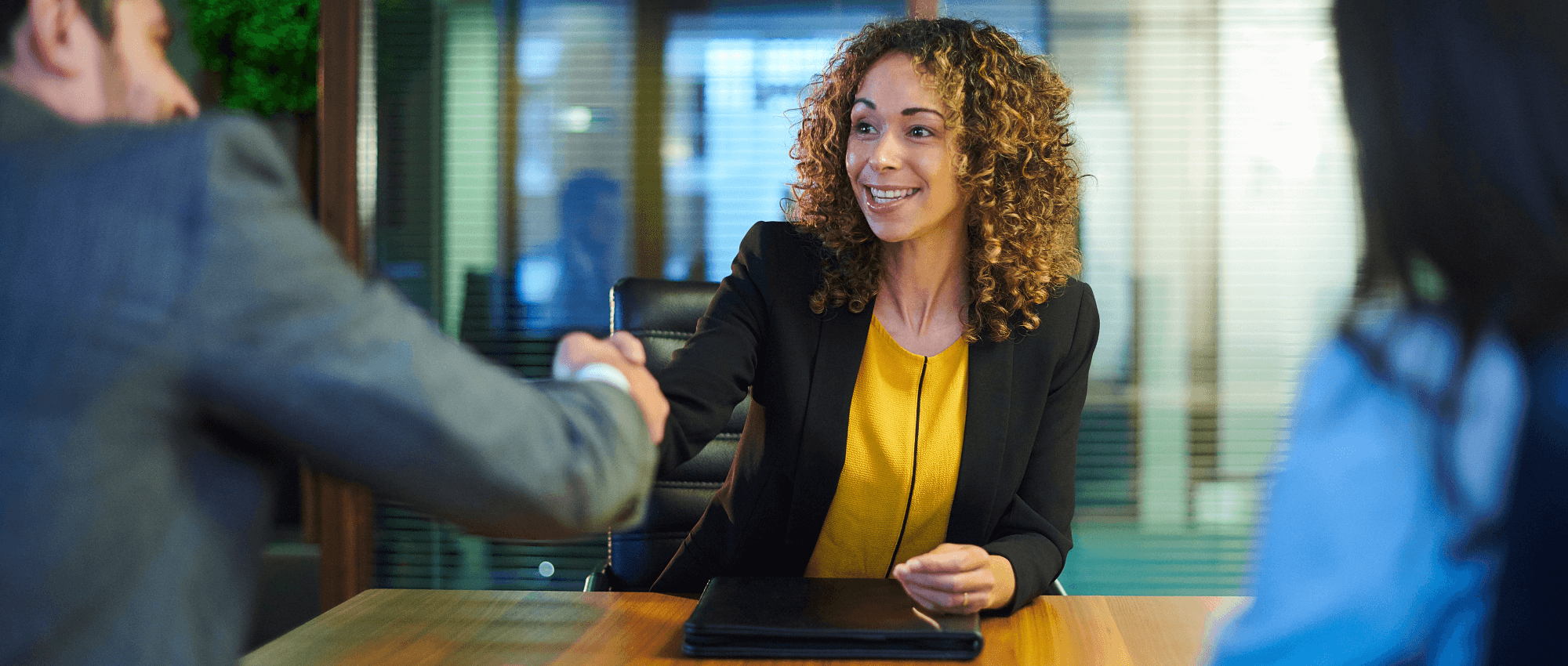 Businesswoman shaking a person's hand