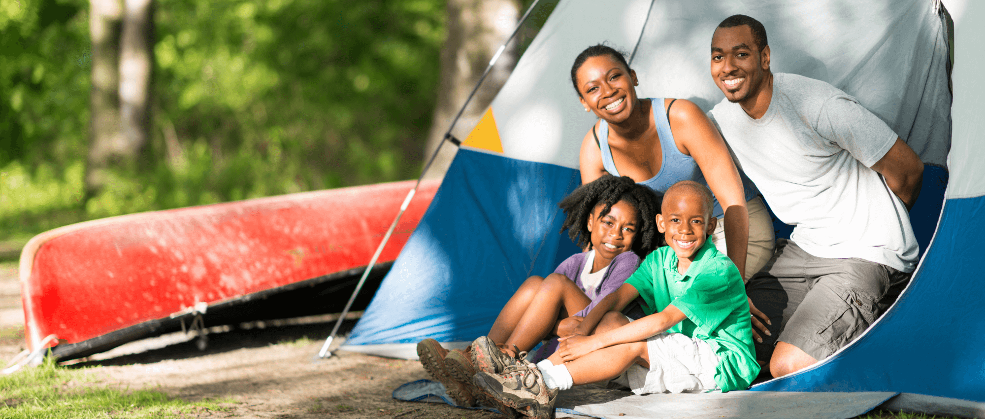 Family under a camping tent