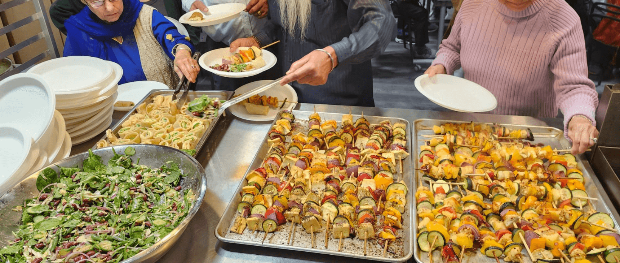 People taking food from food platters