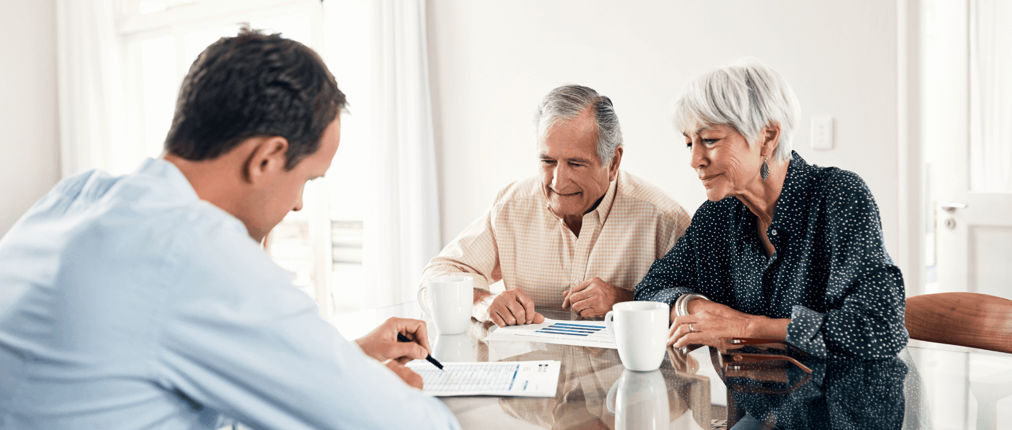 Person consulting two seniors