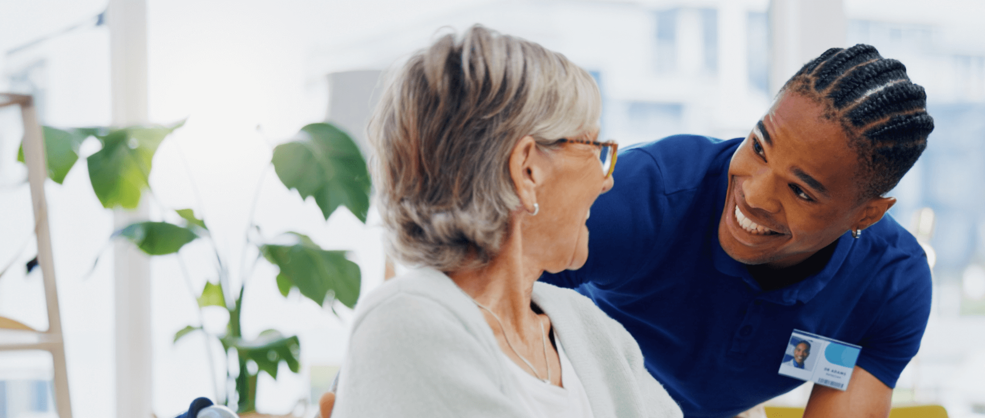A nurse helping out an older woman