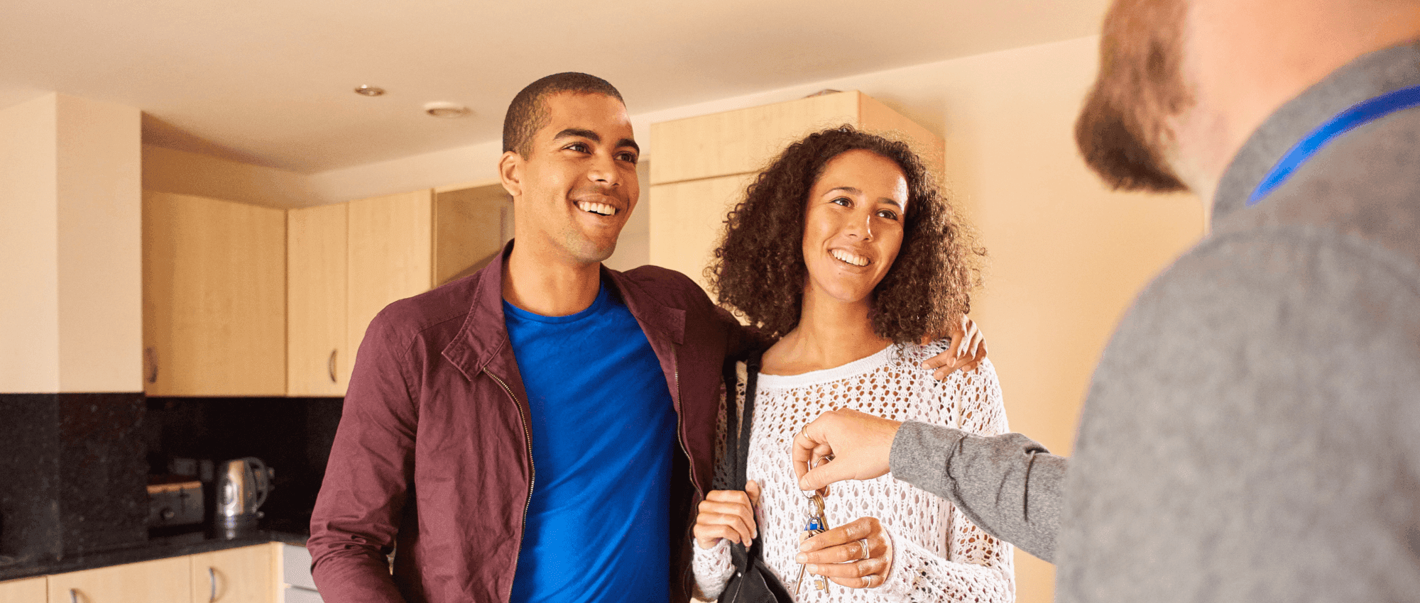 A couple receiving the keys for their house