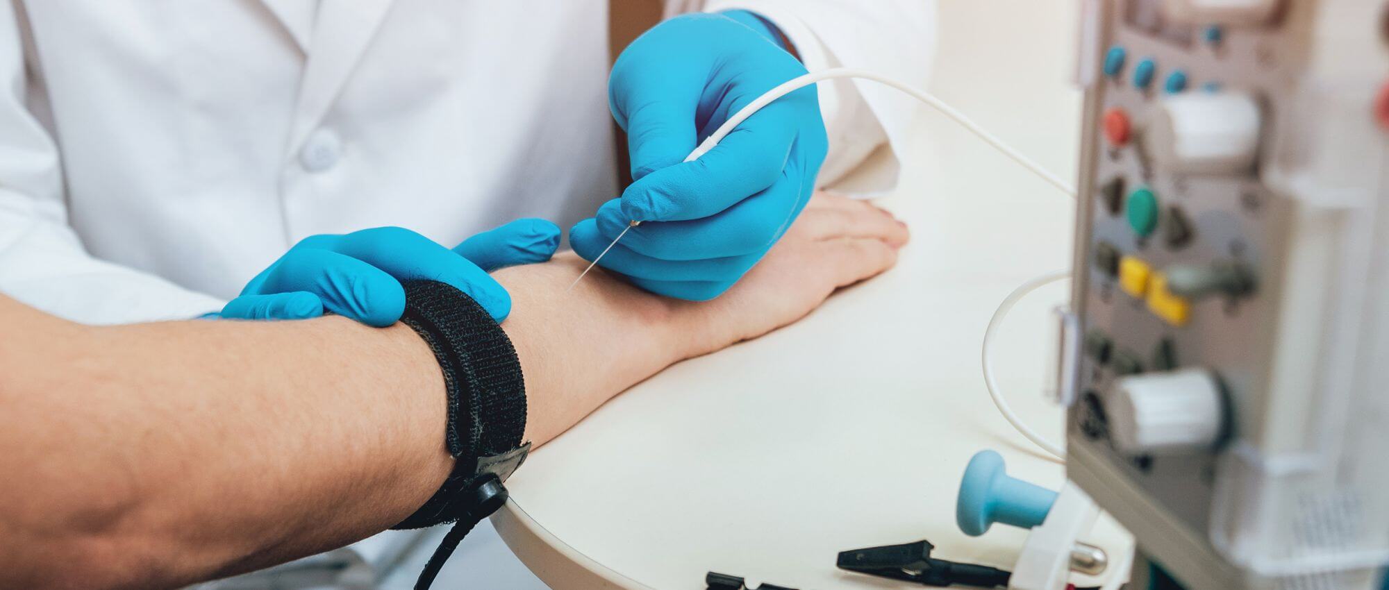 A technician withdrawing blood